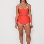 Woman wearing a red two-piece swimsuit on a white background