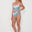 Woman wearing a blue and white patterned bikini on a white background