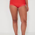 Person wearing red high-waisted original betty bottom shorts on a white background